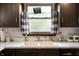 Kitchen sink features charming window curtains, countertop accessories, and natural light at 5631 N Olivia Dr, Alexandria, IN 46001