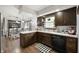 The kitchen features classic wood cabinets, white countertops, and a black and white floor mat at 5631 N Olivia Dr, Alexandria, IN 46001