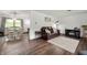 Spacious living room connects to dining area, featuring stylish hardwood floors and neutral walls at 5631 N Olivia Dr, Alexandria, IN 46001