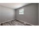 Bedroom featuring hard surface floors, neutral-colored walls, and a window at 5806 E 19Th St, Indianapolis, IN 46218