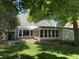 Spacious backyard with brick patio, sunroom, and mature trees at 5889 Crestview Ave, Indianapolis, IN 46220