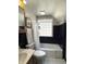 Cozy bathroom with blue tile accents, tub-shower combo, and a traditional sink at 5889 Crestview Ave, Indianapolis, IN 46220