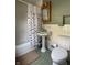 Bathroom with a shower-tub combo, unique vessel sink, and white tile at 5889 Crestview Ave, Indianapolis, IN 46220