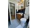 Bathroom with blue tile floor, wood vanity, and decorative mirror at 5889 Crestview Ave, Indianapolis, IN 46220