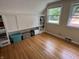 Bright bedroom with built-in storage, hardwood floors, and two windows at 5889 Crestview Ave, Indianapolis, IN 46220