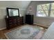 Bedroom with a dresser, dark hardwood floors, a patterned rug, and a sunny window view at 5889 Crestview Ave, Indianapolis, IN 46220