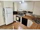 Functional kitchen featuring wood cabinets, a gas range, and matching appliances at 5889 Crestview Ave, Indianapolis, IN 46220