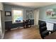 Cozy living room featuring hardwood floors, neutral paint, and a bright window at 5889 Crestview Ave, Indianapolis, IN 46220