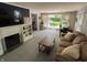 Bright living room featuring a fireplace, a dining table, and a large window at 5889 Crestview Ave, Indianapolis, IN 46220