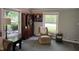 Cozy living room featuring an armchair, a cabinet, and natural light from the windows at 5889 Crestview Ave, Indianapolis, IN 46220