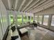 Spacious sunroom with comfortable seating, dining area, and multiple windows overlooking the yard at 5889 Crestview Ave, Indianapolis, IN 46220