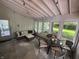 Inviting sunroom with ample seating, stylish rug, and views of the backyard at 5889 Crestview Ave, Indianapolis, IN 46220