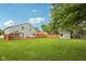Wide backyard showcasing a deck, gazebo, shed, and expansive green space, ideal for outdoor living at 604 Alexandria Pike, Anderson, IN 46012