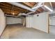 Unfinished basement with concrete floor, exposed rafters and open duct work at 604 Alexandria Pike, Anderson, IN 46012