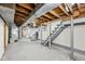 Unfinished basement with stairs, exposed pipes, and utility connections at 604 Alexandria Pike, Anderson, IN 46012