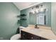 Stylish bathroom featuring a granite vanity, a decorative mirror, and elegant wall sconces at 604 Alexandria Pike, Anderson, IN 46012
