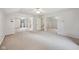 Expansive bedroom with mirrored closet doors, ceiling fan, and neutral carpet at 604 Alexandria Pike, Anderson, IN 46012