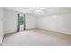 Spacious bedroom with neutral carpet, ceiling fan, and a bright window at 604 Alexandria Pike, Anderson, IN 46012