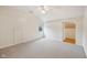 Bright bedroom featuring neutral walls and carpet, ceiling fan, and an open closet at 604 Alexandria Pike, Anderson, IN 46012