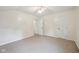 Neutral bedroom with carpeted floor, a ceiling fan, and access to another room at 604 Alexandria Pike, Anderson, IN 46012