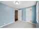 Bright bedroom featuring light blue walls, neutral carpet, and multiple doors for easy access at 604 Alexandria Pike, Anderson, IN 46012