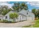 This house features light blue siding, a basketball hoop over the garage, and a lovely tree in the front yard at 604 Alexandria Pike, Anderson, IN 46012