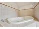 A luxurious jetted tub surrounded by ceramic tile and decor at 604 Alexandria Pike, Anderson, IN 46012