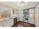Charming kitchen featuring stainless steel appliances, custom cabinetry, and modern fixtures, creating a functional and stylish space at 604 Alexandria Pike, Anderson, IN 46012