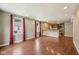 Sunlit living room area with hardwood floors seamlessly connecting to an open kitchen space with recessed lights at 604 Alexandria Pike, Anderson, IN 46012