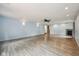 Bright and airy living room features sleek flooring, recessed lighting, a ceiling fan, and a cozy corner fireplace at 604 Alexandria Pike, Anderson, IN 46012