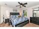 Bedroom featuring ceiling fan, painting, window with curtains, and dresser at 6553 Black Antler Dr, Indianapolis, IN 46217