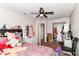 Bedroom features a floral bed spread, ceiling fan, and closet at 6553 Black Antler Dr, Indianapolis, IN 46217