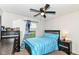Cozy bedroom featuring a ceiling fan, window with curtains, and comfortable bed with blue and white comforter at 6553 Black Antler Dr, Indianapolis, IN 46217