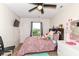 A bright bedroom including a window, floral bedding, and ceiling fan at 6553 Black Antler Dr, Indianapolis, IN 46217