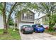 Two-story home with tan siding, dark shutters, and a two-car garage, plus driveway parking at 6553 Black Antler Dr, Indianapolis, IN 46217