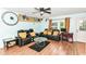 Cozy living room with leather couches, wood-look flooring, and a ceiling fan at 6553 Black Antler Dr, Indianapolis, IN 46217