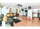 Open-concept living room featuring wood-look floors, a fireplace, and access to the kitchen at 6553 Black Antler Dr, Indianapolis, IN 46217