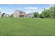 Large backyard with a lush lawn featuring a pergola, perfect for outdoor activities and relaxation at 6917 Wolf Creek Ct, Whitestown, IN 46075