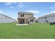 Expansive backyard features a well-maintained lawn and a pergola with an outdoor kitchen at 6917 Wolf Creek Ct, Whitestown, IN 46075