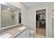 Bathroom featuring double vanity, large mirror, and walk-in shower with neutral finishes at 6917 Wolf Creek Ct, Whitestown, IN 46075