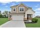 Charming two-story home boasts a manicured lawn, attached two-car garage, and a welcoming facade at 6917 Wolf Creek Ct, Whitestown, IN 46075