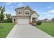 Charming two-story home boasting a large driveway, an attached garage, and inviting curb appeal at 6917 Wolf Creek Ct, Whitestown, IN 46075