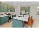 Modern kitchen features painted cabinets, stainless steel appliances, and a quartz countertop island at 6917 Wolf Creek Ct, Whitestown, IN 46075