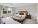 The main bedroom has a comfortable bed, wooden furnishings, large window and soft carpet at 6917 Wolf Creek Ct, Whitestown, IN 46075