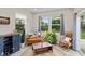 Bright sun room features neutral colors, wooden furniture, many plants and plenty of natural light at 6917 Wolf Creek Ct, Whitestown, IN 46075
