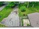 An aerial view shows the driveway, a small concrete patio, and the roof of the home at 741 Fairway Dr, Indianapolis, IN 46260