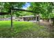 View of backyard with patio, seating, hot tub, and stone house exterior at 741 Fairway Dr, Indianapolis, IN 46260