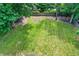 The backyard is spacious with a large grassy area, playset, and wooden fence at 741 Fairway Dr, Indianapolis, IN 46260