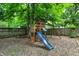 Charming backyard featuring a wooden playset, slide, and swings, perfect for Gathering fun at 741 Fairway Dr, Indianapolis, IN 46260
