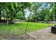 Spacious backyard with lush lawn, trees, and patio area at 741 Fairway Dr, Indianapolis, IN 46260